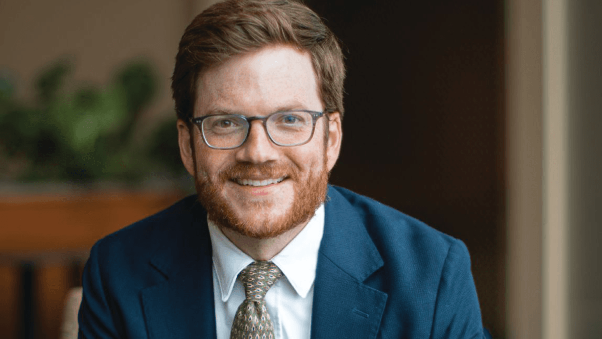 Dr. Newton Wiggins sitting and smiling